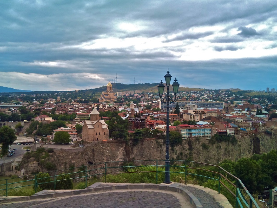 The view from the Narikala fortress over the city of Tbilisi, with views of the Sameba Cathedral and the Mtkvari River.